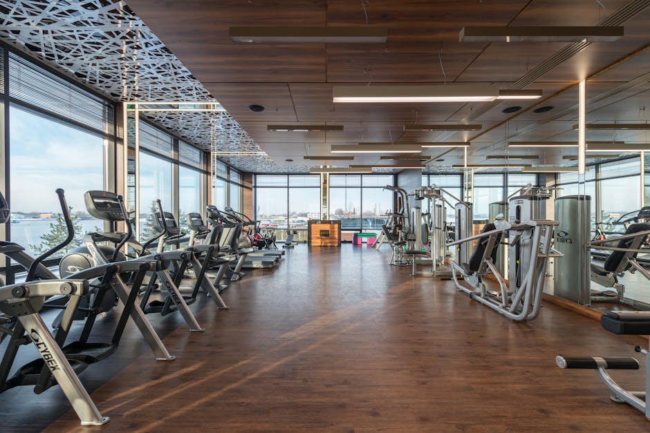Precor commercial gym treadmill and elliptical machines in modern fitness studio
