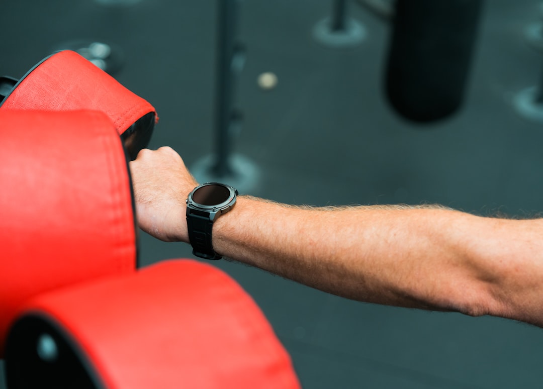 athlete wearing heart rate monitor armband during gym workout