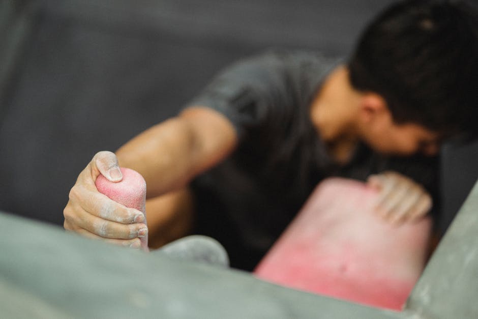 climber doing hangboard training on woody board at home