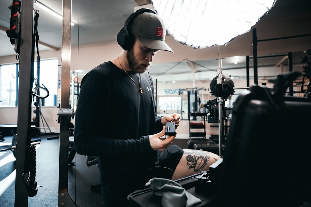 crossfit athlete logging workout score on smartphone after training session