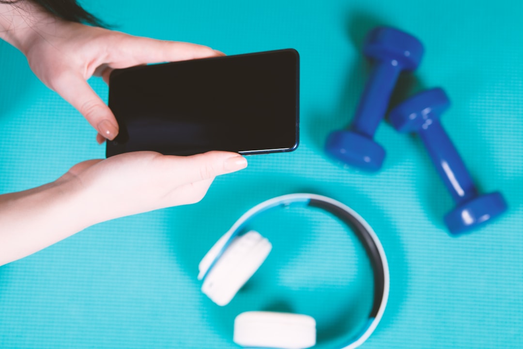 fitness app on smartphone screen with workout video playing
