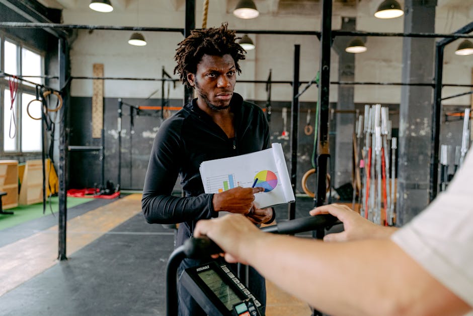 fitness trainer reviewing client data on tablet in modern gym studio