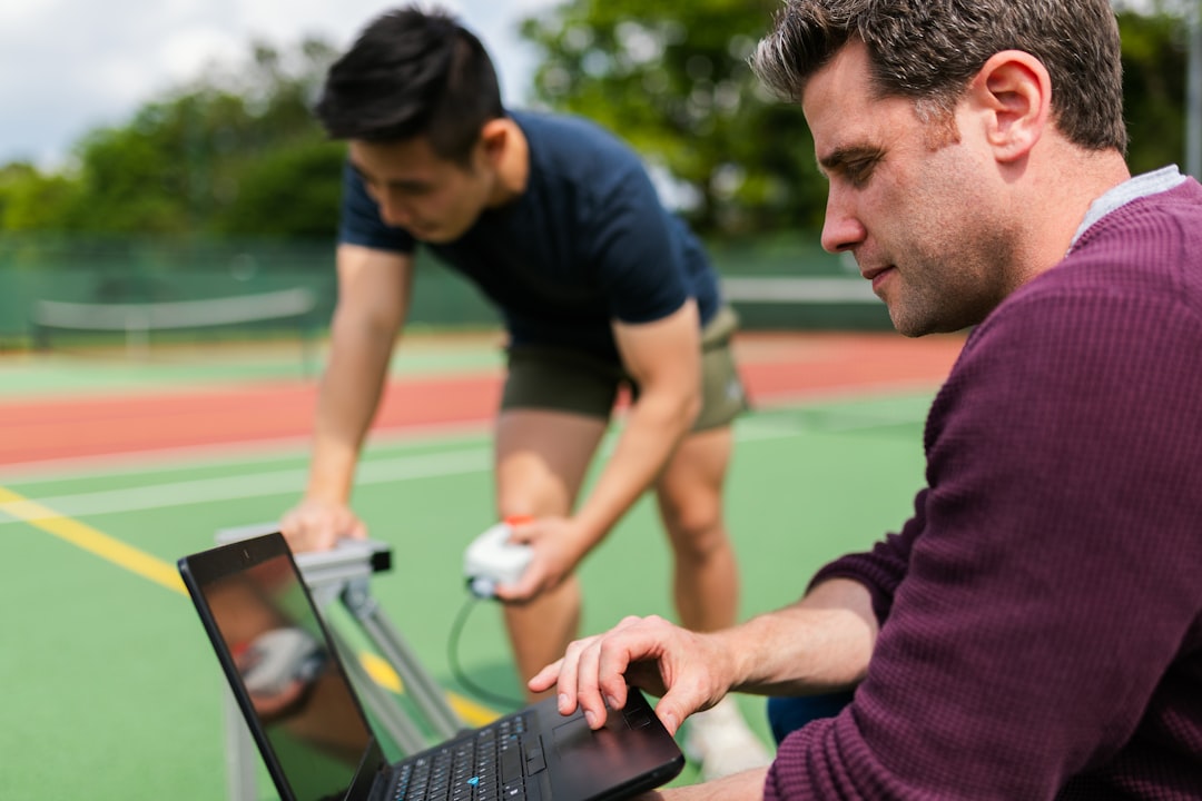 fitness trainer using laptop dashboard for client management