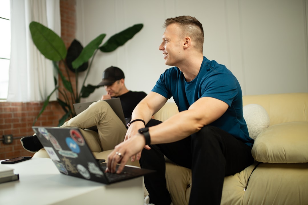 gym owner reviewing studio management software on laptop pros and cons