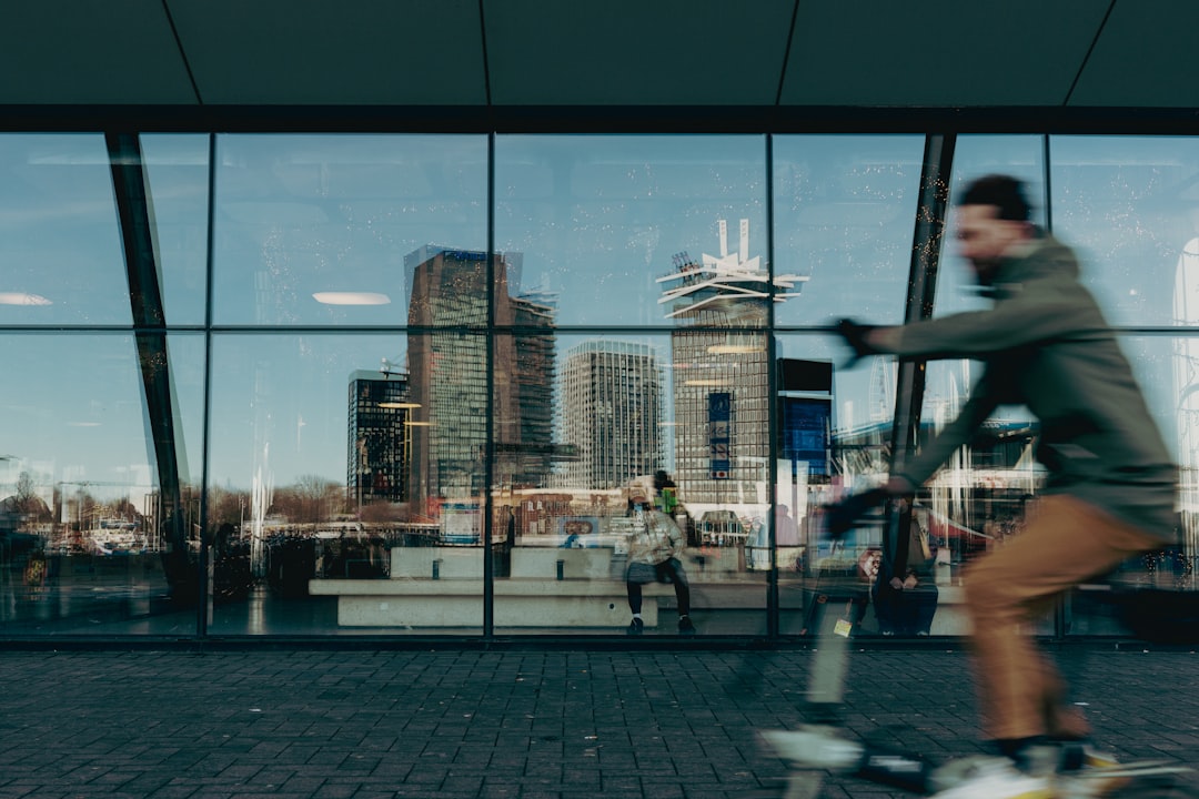 person cycling indoors on a stationary bike with a large screen showing a virtual landscape