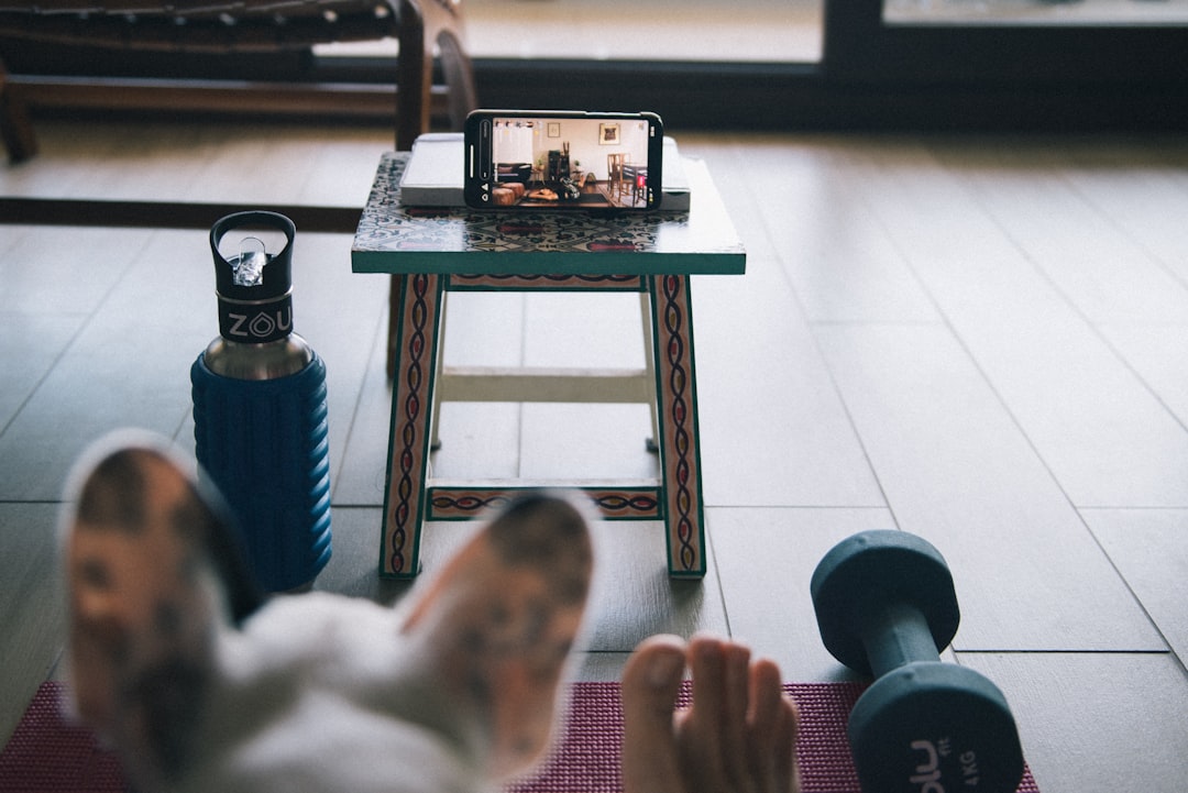 person doing home workout using tablet and smartwatch
