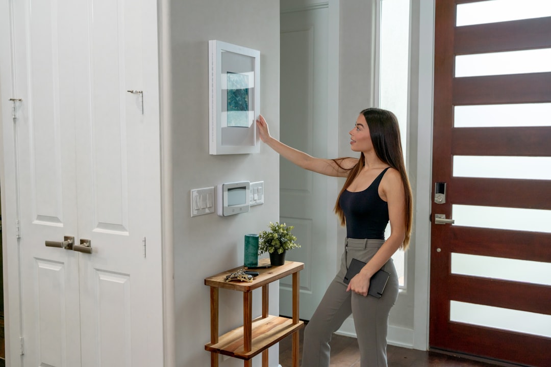 person exercising in front of a wall-mounted fitness display screen at home