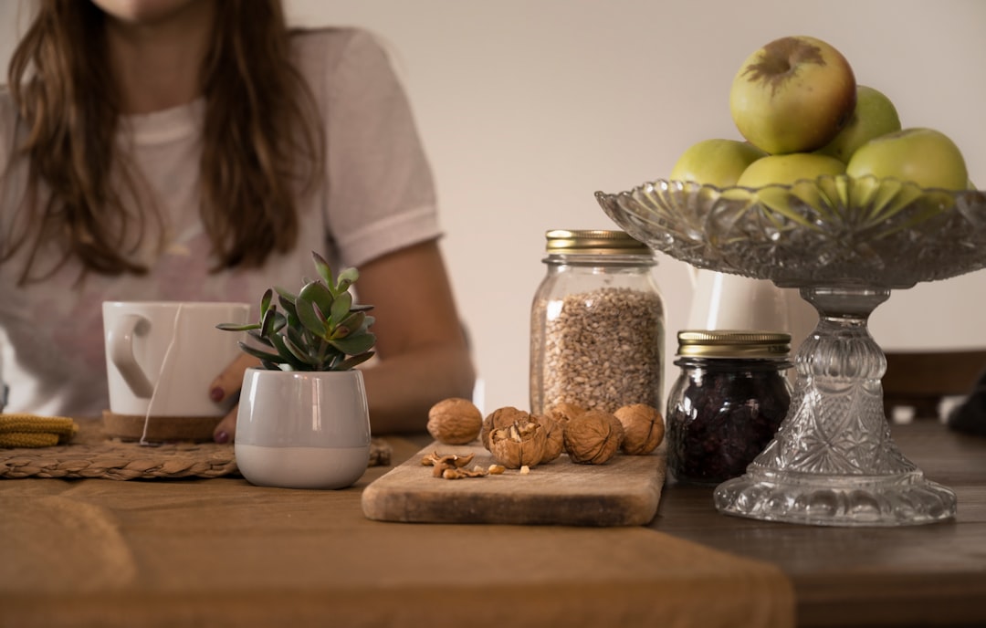 person logging food on nutrition tracking app at kitchen table