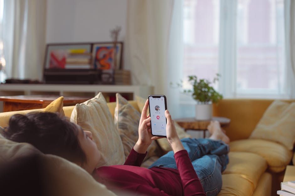 person meditating with smartphone app on screen in calm home setting