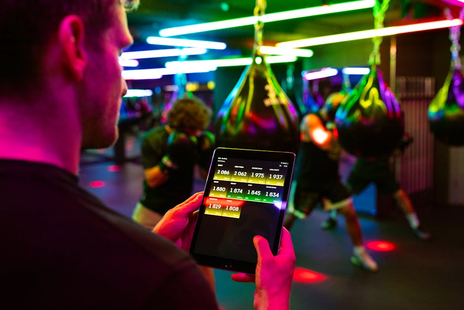 person reviewing fitness data on Notion app on tablet at gym
