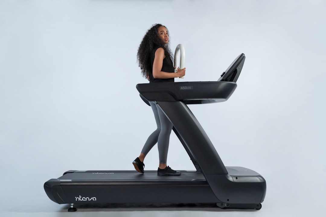 person running on smart treadmill in home gym setting