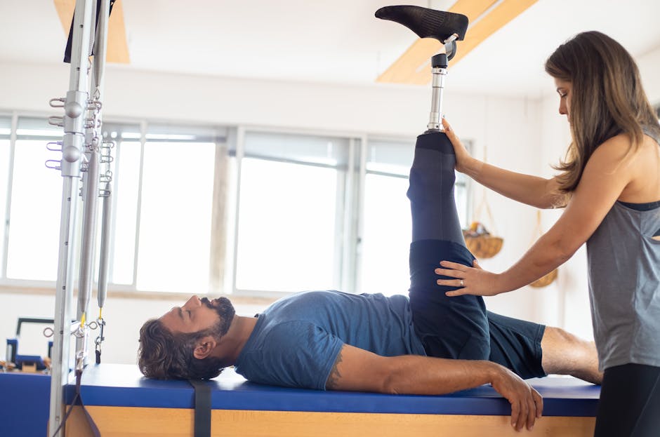 person using Arc Trainer in gym physiotherapy session