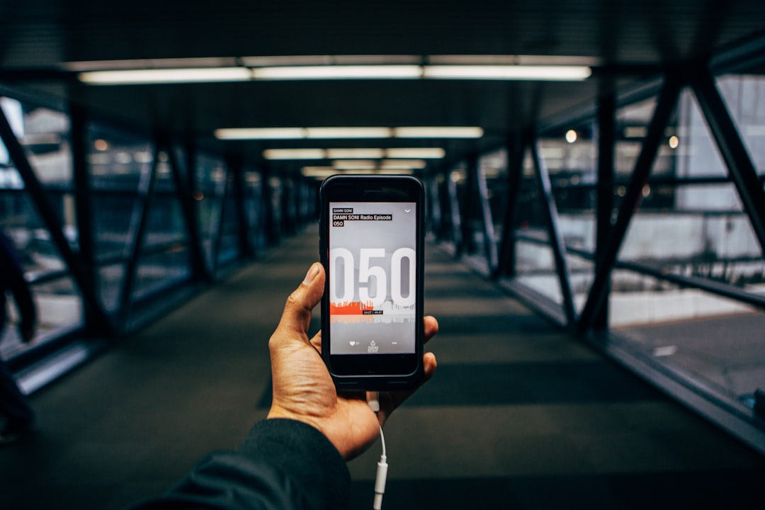 person using fitness app on phone during gym session strength training