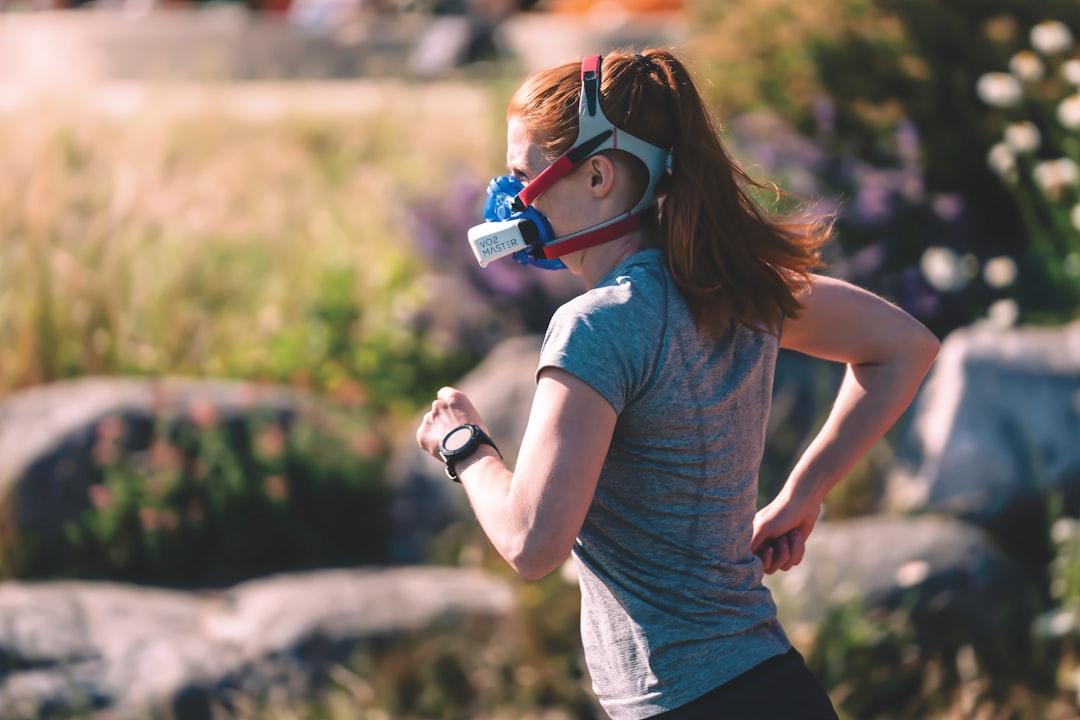 person wearing chest strap heart rate monitor during outdoor run