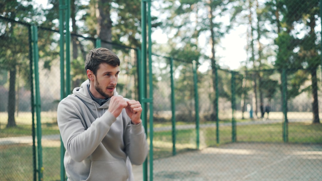 runner checking lightweight sports watch mid-training session outdoors