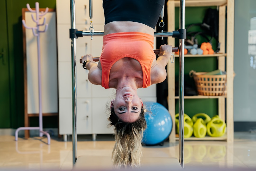 smiling woman exercising on mini trampoline indoors