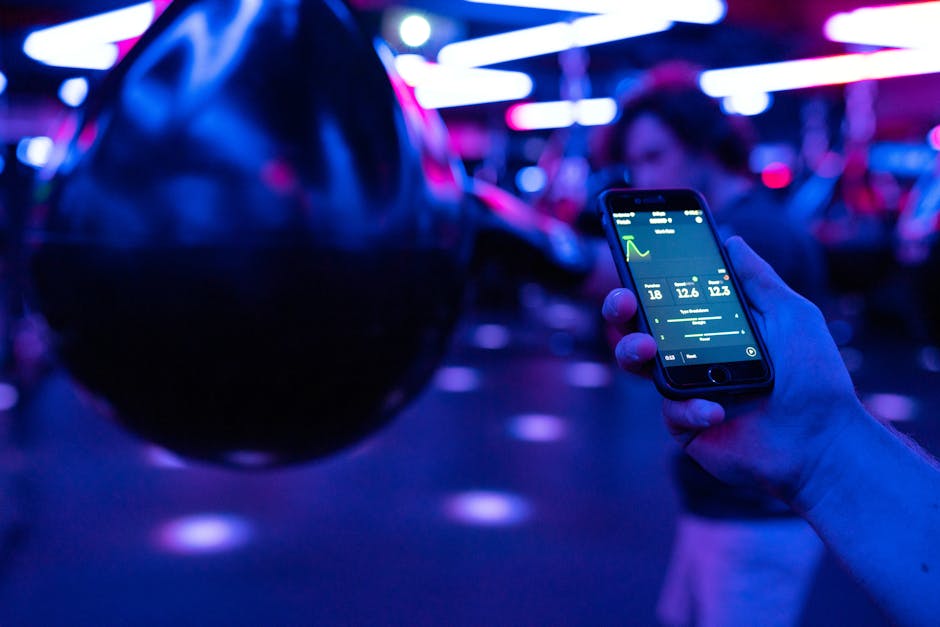 strength training app interface on smartphone in gym