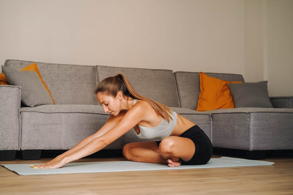 woman performing yoga stretching exercise in bright home living room with large screen