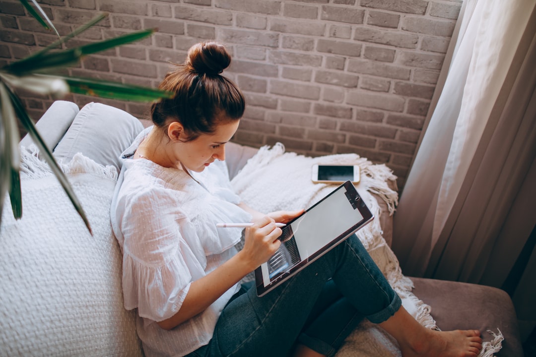 woman using meditation app on tablet during morning routine at home