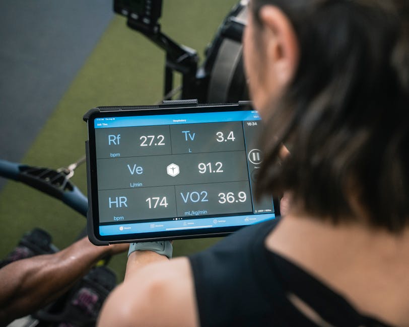 Athlete reviewing biometric data on laptop after training session with Hexoskin shirt