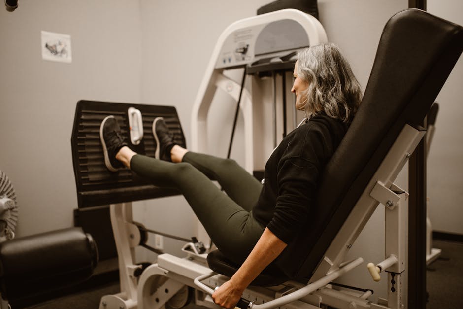 Person using Theragun Prime on quad muscle after a gym workout session