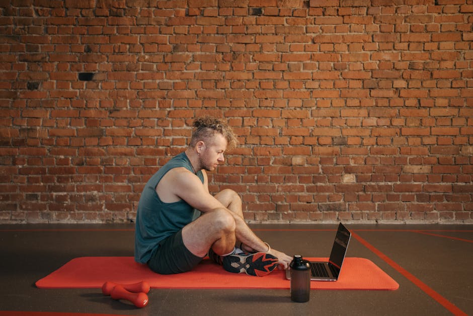 UK personal trainer reviewing gym management software laptop studio