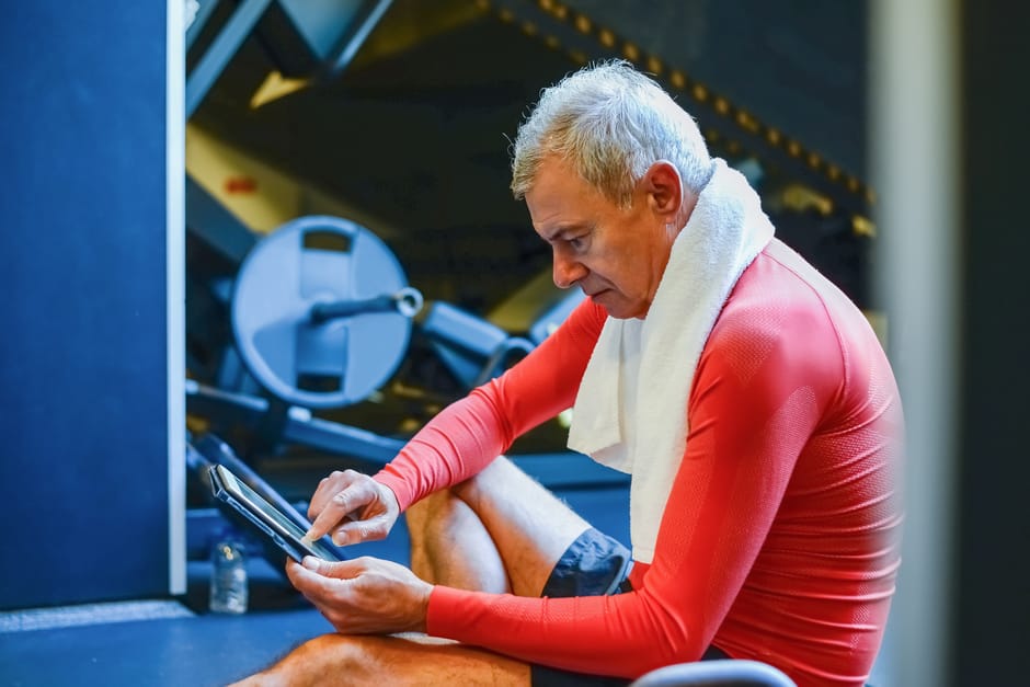 UK personal trainer using gym management software on tablet