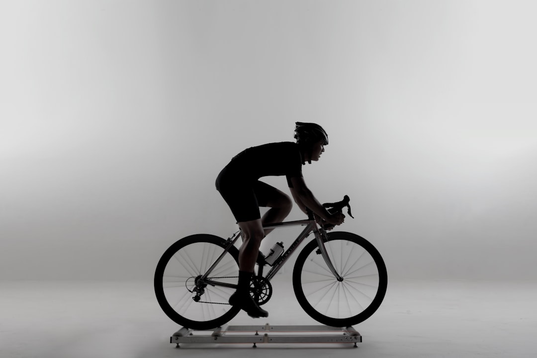 cyclist training indoors on smart bike with data on screen