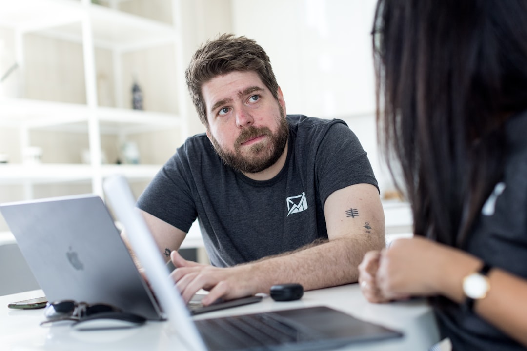 fitness studio owner reviewing management software on laptop