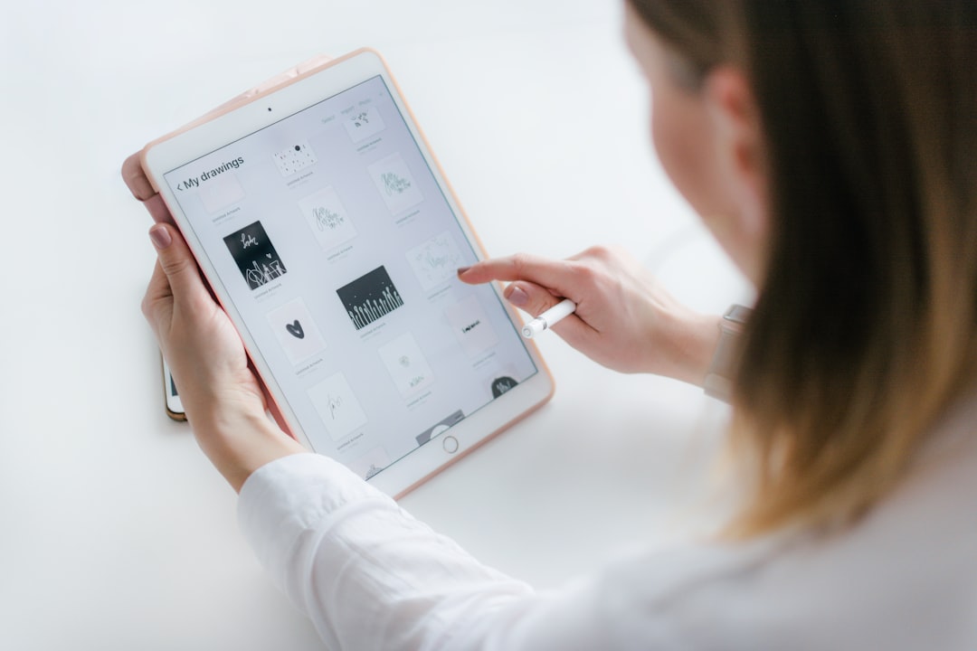 personal trainer reviewing coaching software on tablet