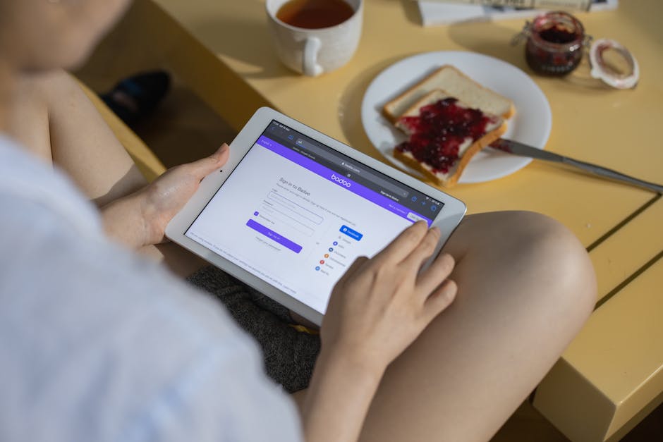 woman reviewing fitness app on tablet at home UK