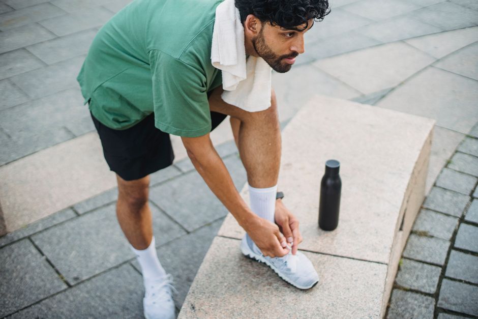 Athlete reviewing Whoop Band Gen 6 data on phone after morning training session