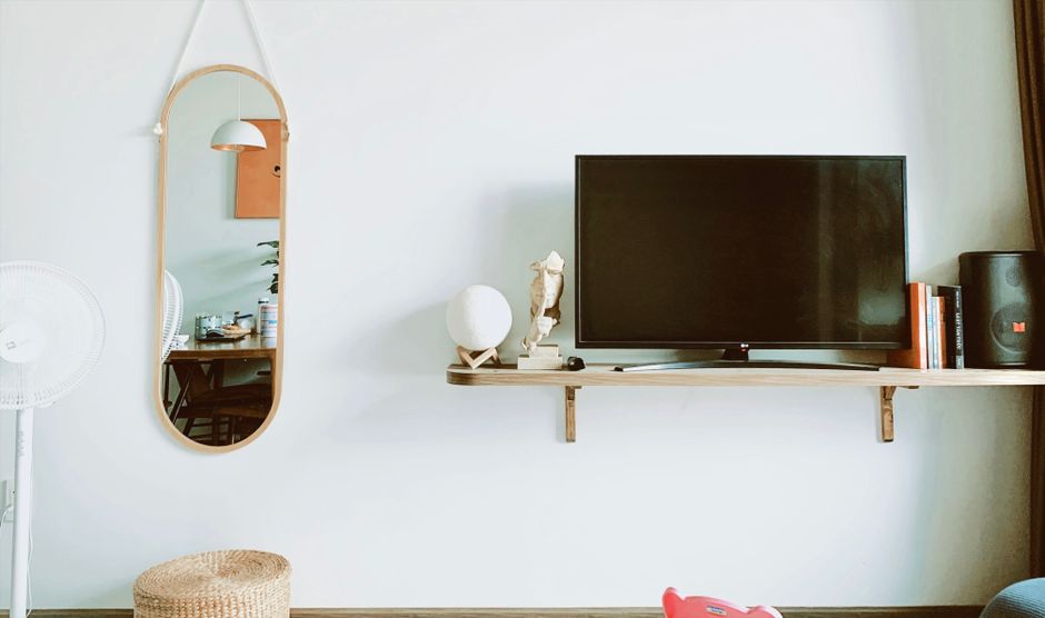Mirror by Lululemon smart fitness mirror mounted on living room wall