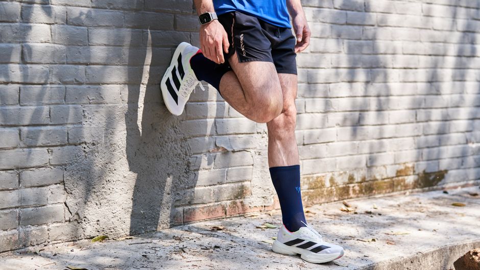 athlete recovering post-run wearing Marena compression calf sleeves