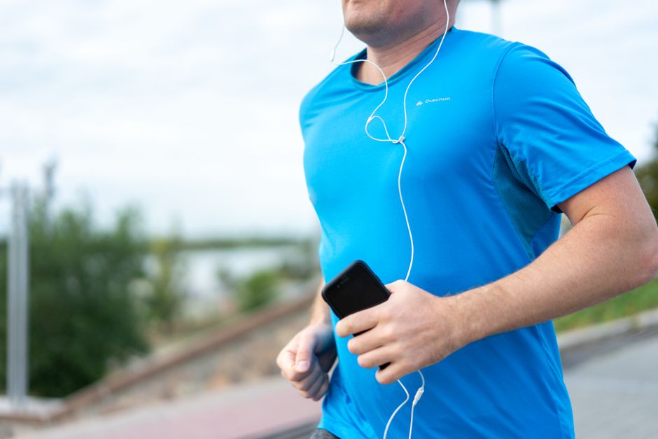 athlete reviewing biometric data on phone after workout with Hexoskin shirt