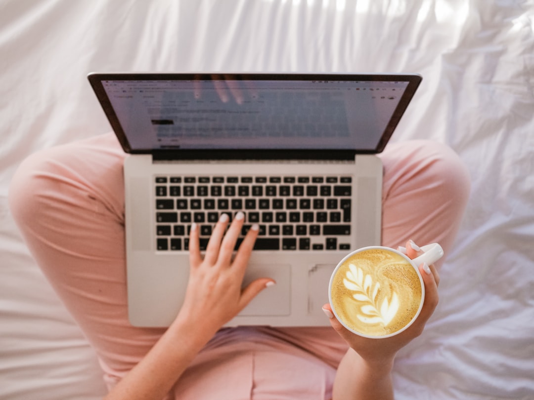 fitness professional reviewing website on laptop coffee shop UK