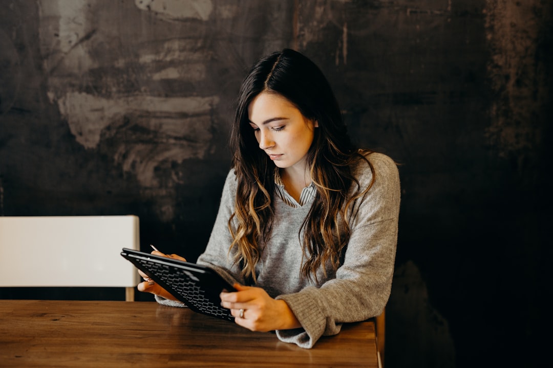 gym owner reviewing fitness studio management software on tablet