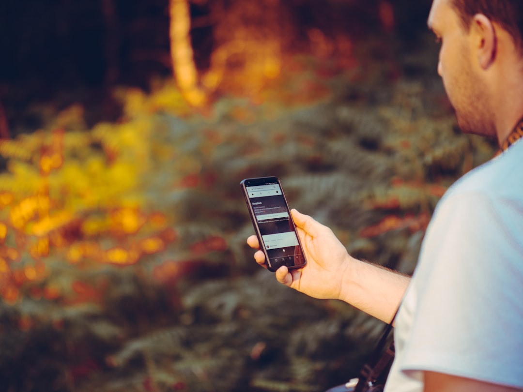 runner comparing running apps on smartphone outdoors