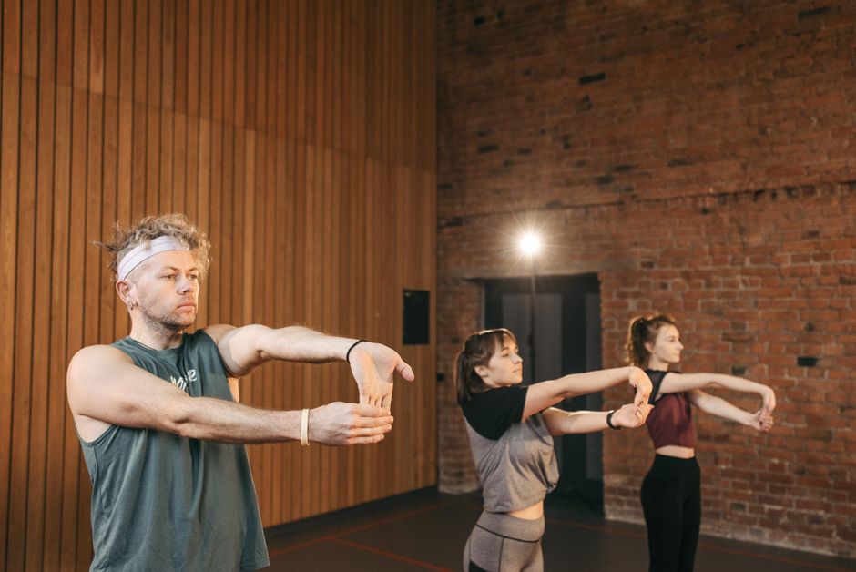 virtual group fitness class playing on a large studio screen in a modern UK gym