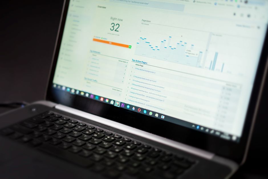 Ultimate Performance online coaching dashboard interface on laptop and smartphone