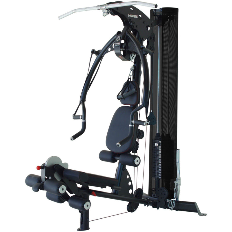 Inspire M2 Multi Gym viewed from the side, showing the weight stack and leg unit