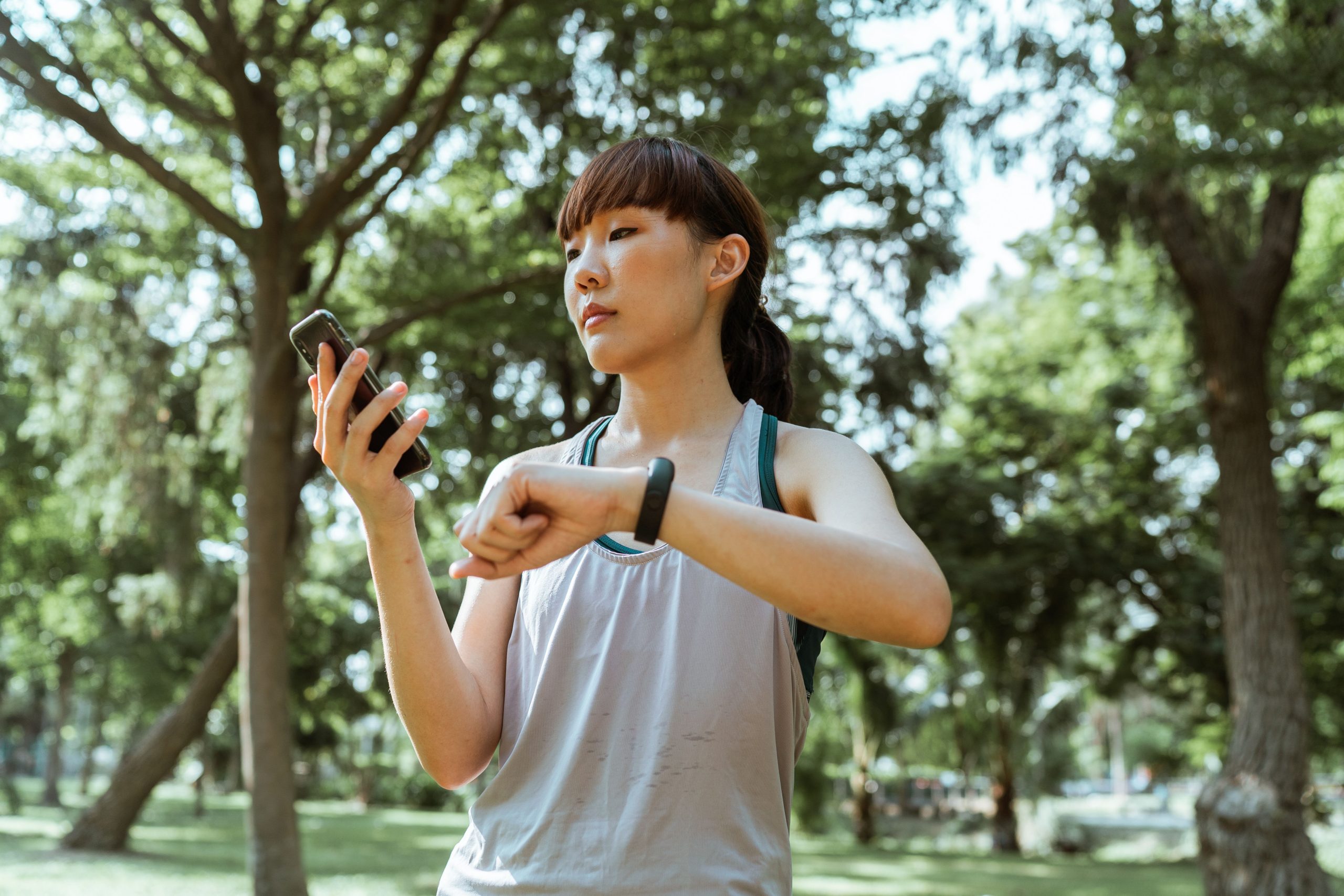 a woman looking at her phone while running