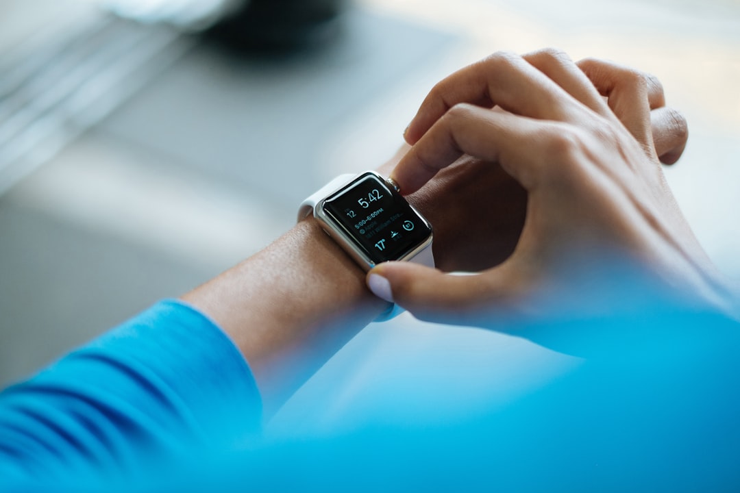 Person checking fitness tracker data on smartphone